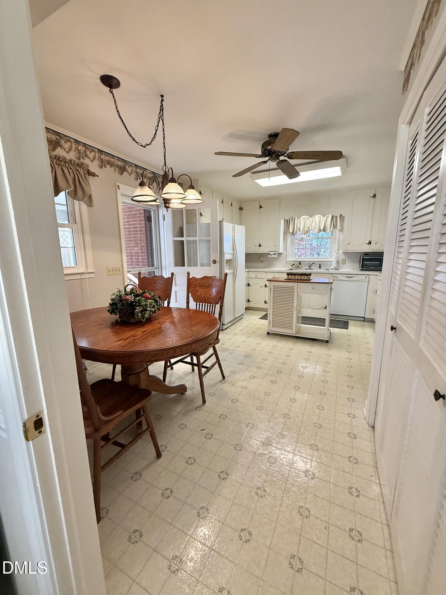 424 Tanglewood Circle Roxboro, NC 27573 - Photo 12 of 47 a dining room filled with furniture and a chandelier