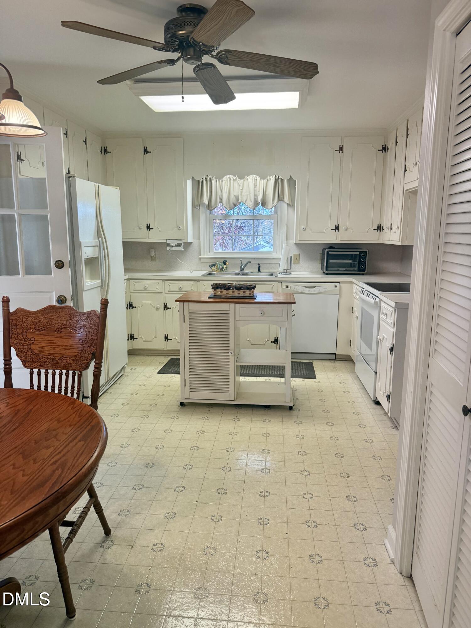 424 Tanglewood Circle Roxboro, NC 27573 - Photo 14 of 47 a kitchen with a cabinets and chairs