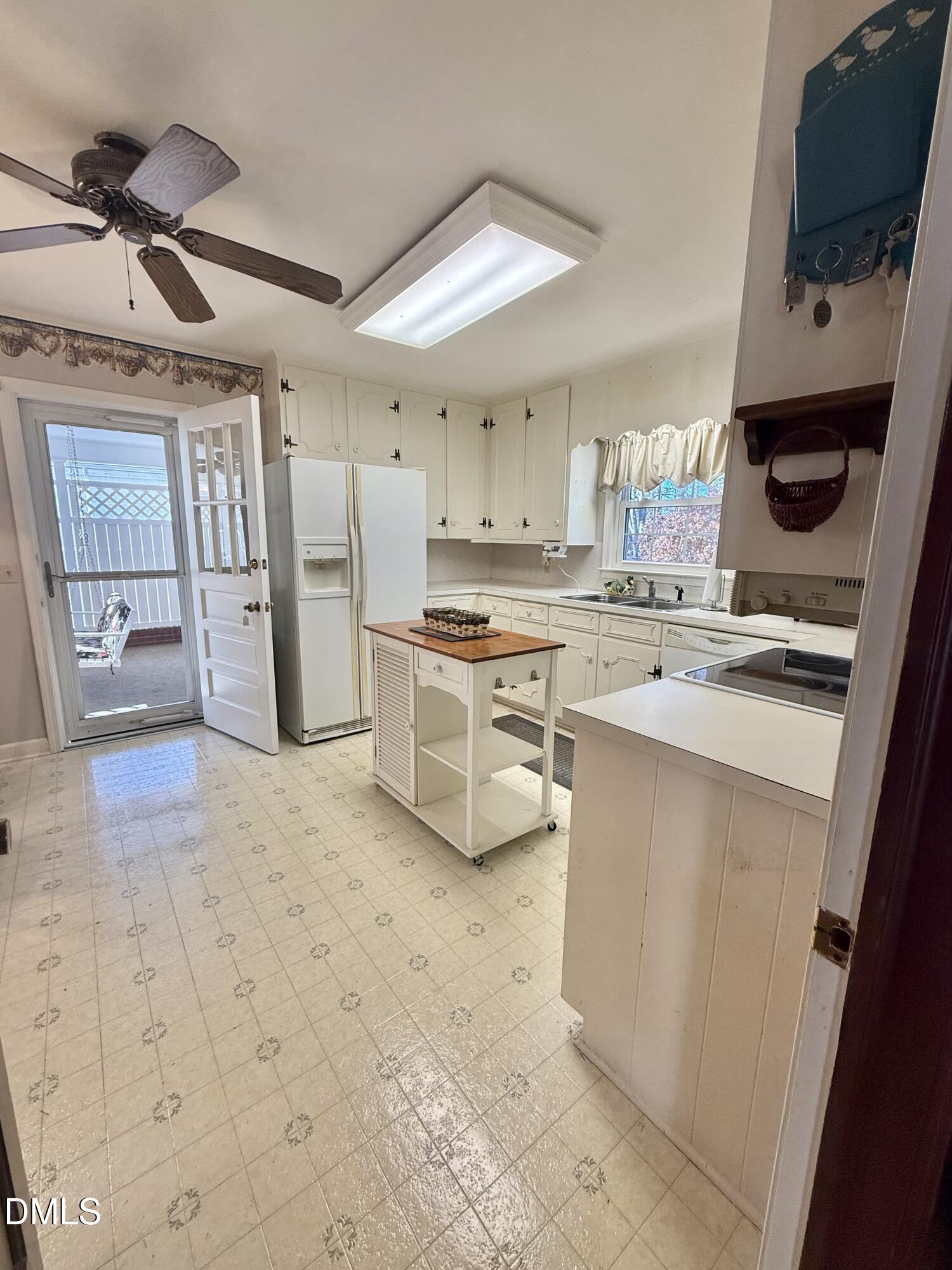 424 Tanglewood Circle Roxboro, NC 27573 - Photo 17 of 47 a kitchen with stainless steel appliances a stove a sink and a refrigerator