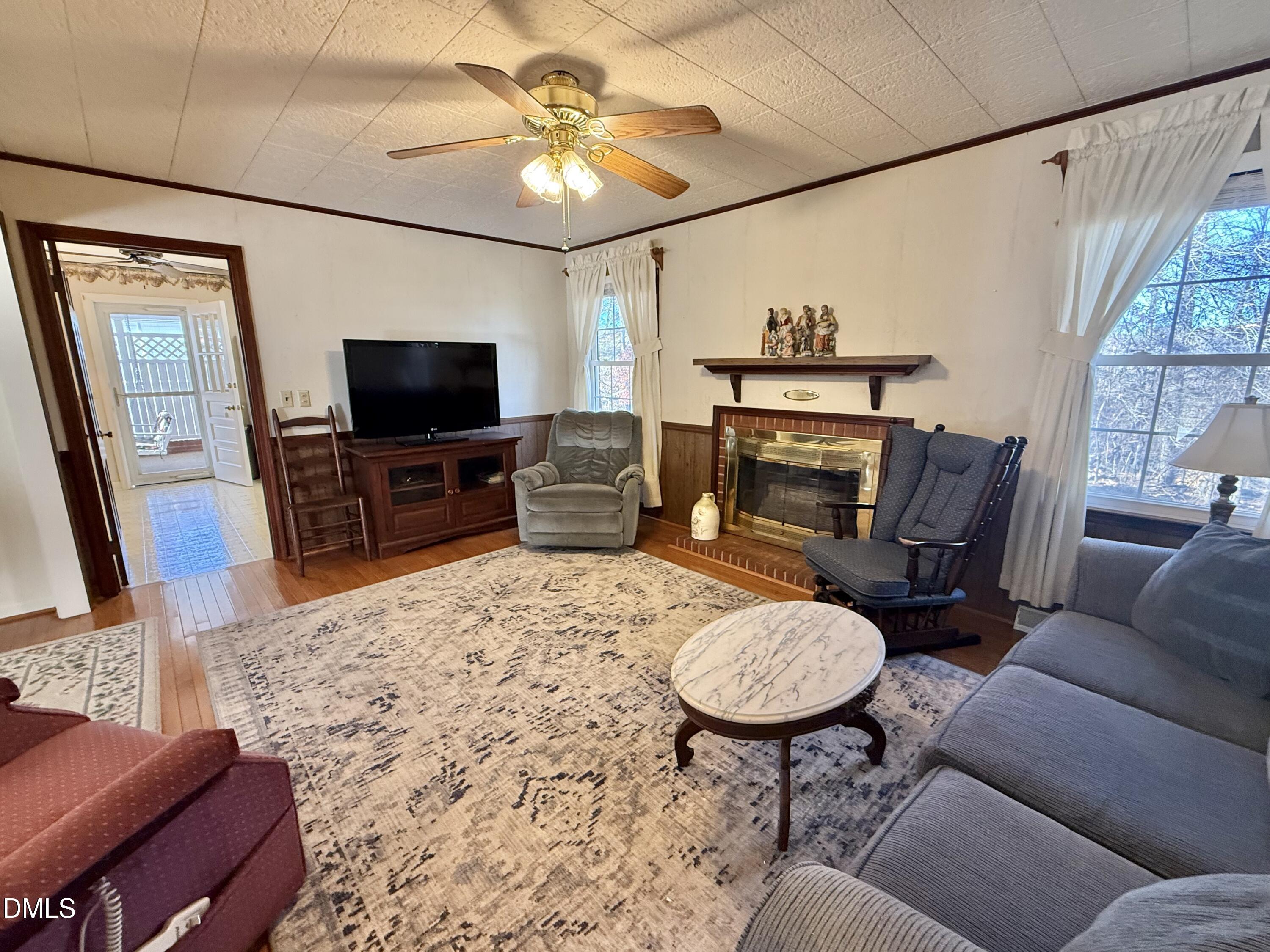 424 Tanglewood Circle Roxboro, NC 27573 - Photo 22 of 47 a living room with furniture a flat screen tv and a fireplace