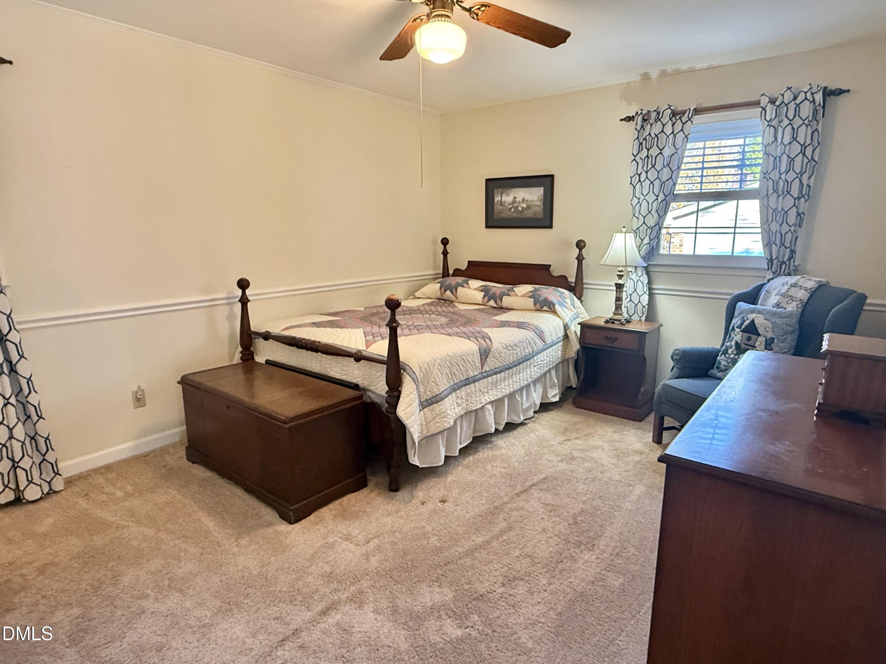 424 Tanglewood Circle Roxboro, NC 27573 - Photo 27 of 47 a bedroom with bed couch and window