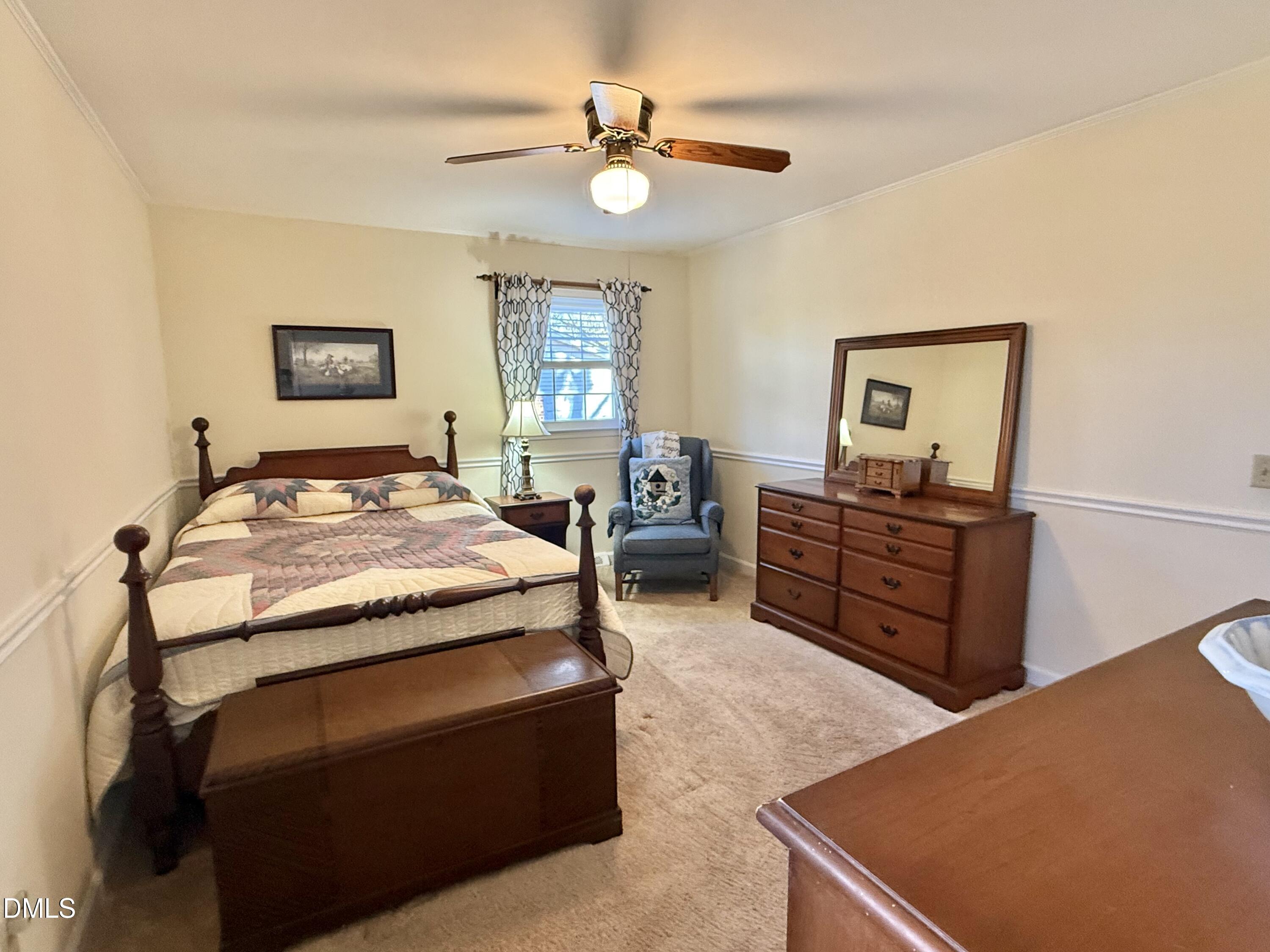 424 Tanglewood Circle Roxboro, NC 27573 - Photo 29 of 47 a bedroom with a bed and wooden floor