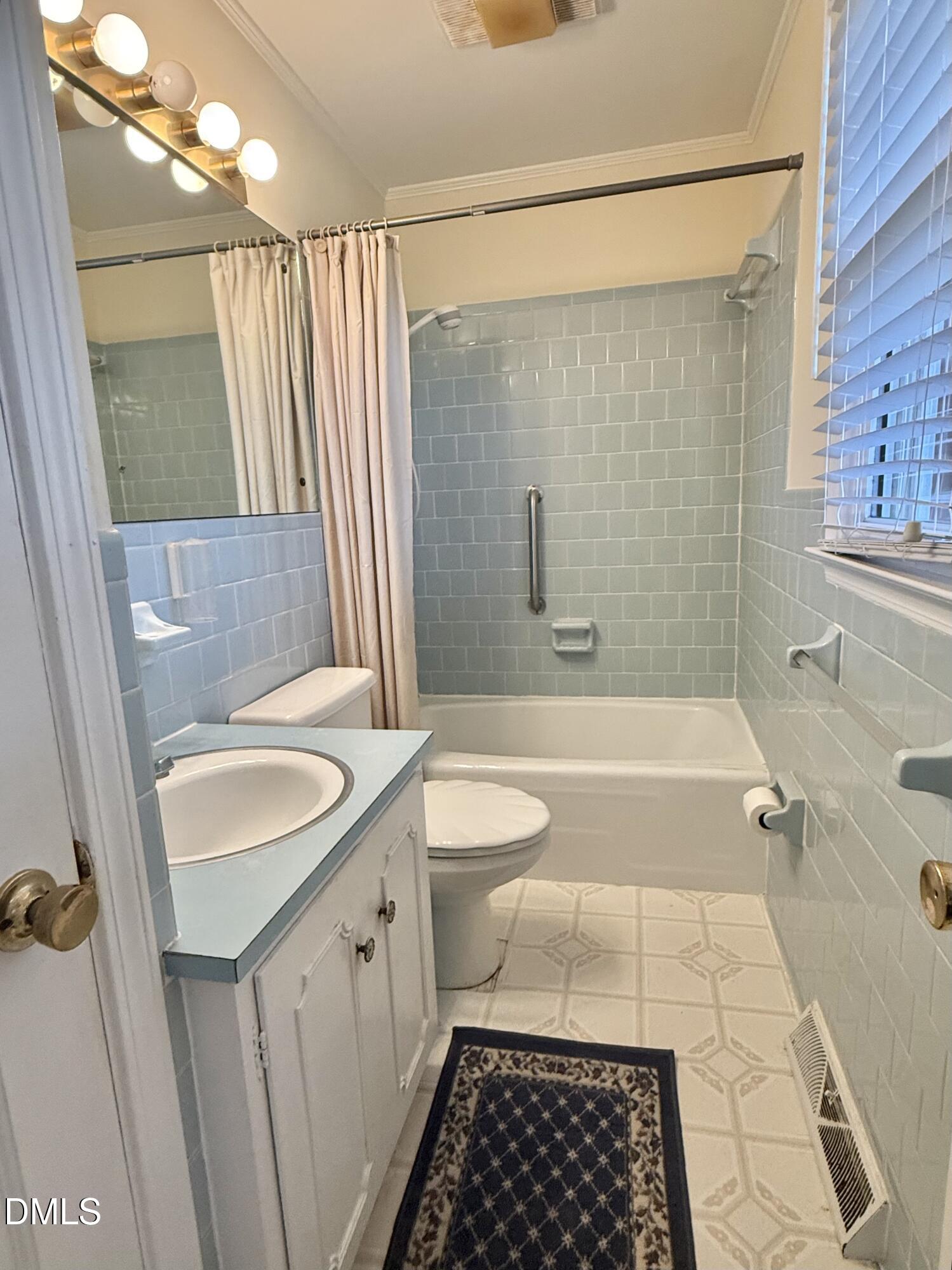 424 Tanglewood Circle Roxboro, NC 27573 - Photo 31 of 47 a bathroom with a granite countertop sink a toilet a mirror and shower