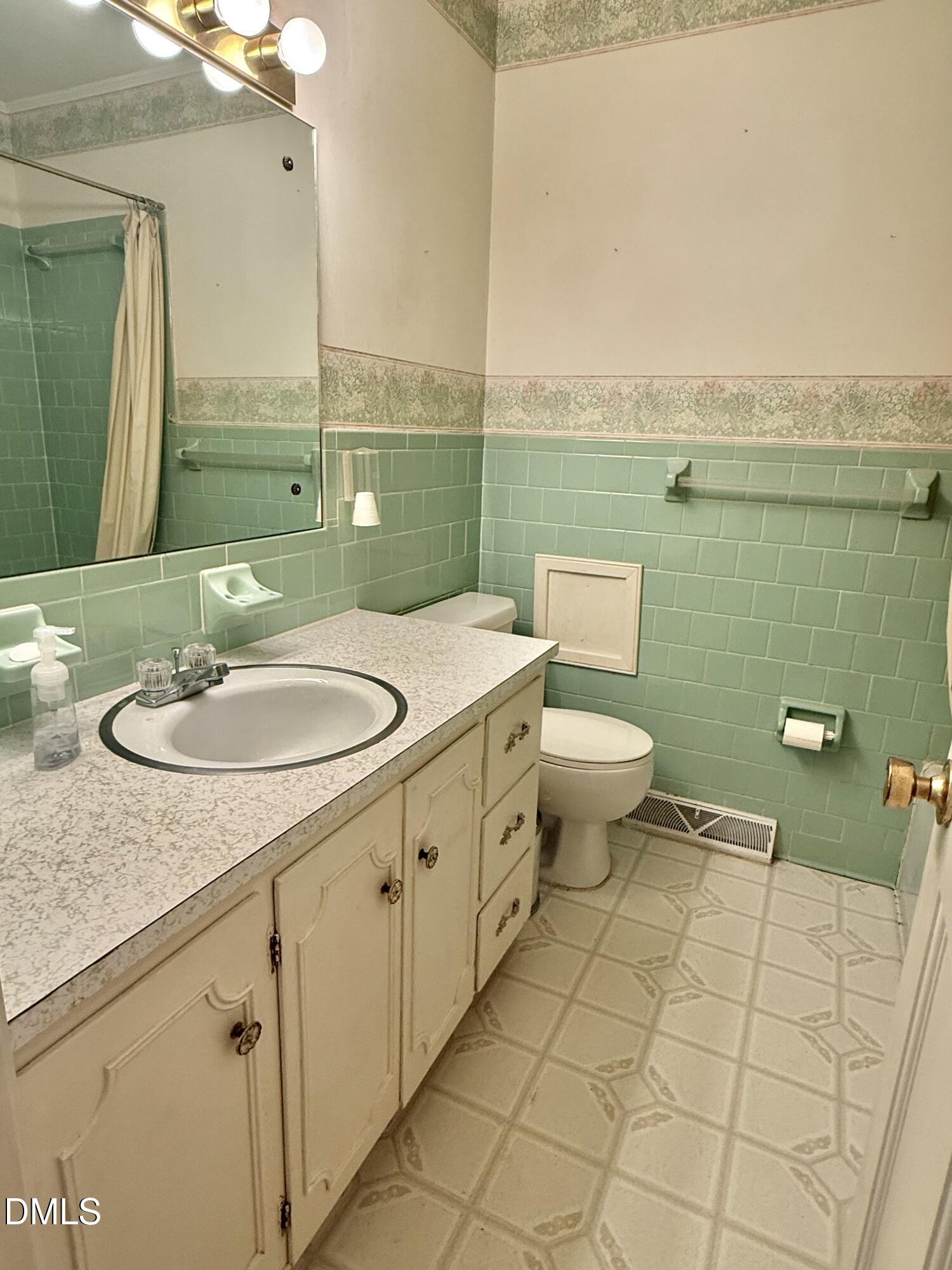 424 Tanglewood Circle Roxboro, NC 27573 - Photo 34 of 47 a bathroom with a sink toilet and mirror