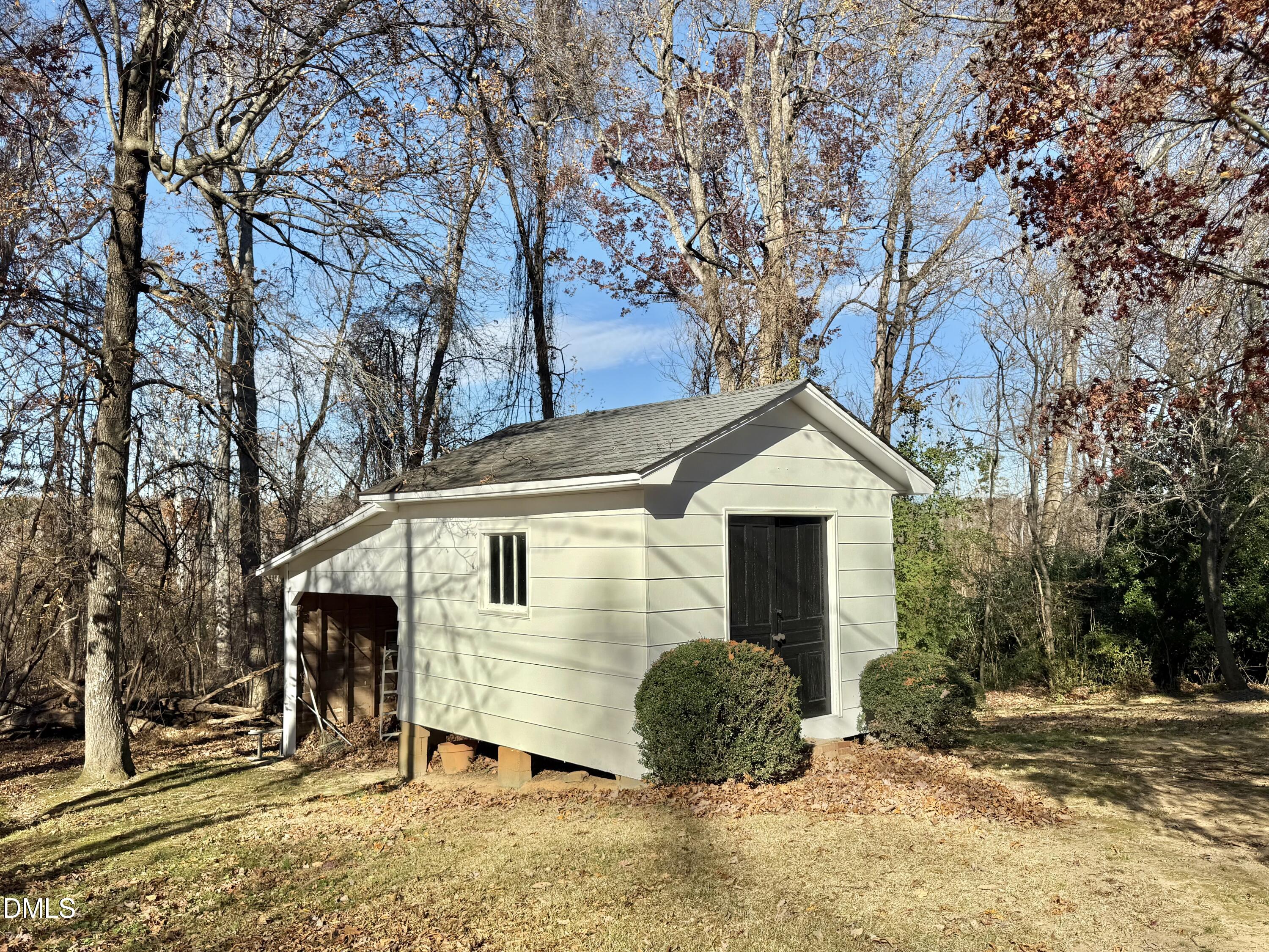 424 Tanglewood Circle Roxboro, NC 27573 - Photo 44 of 47 a front view of a house with a yard and garage
