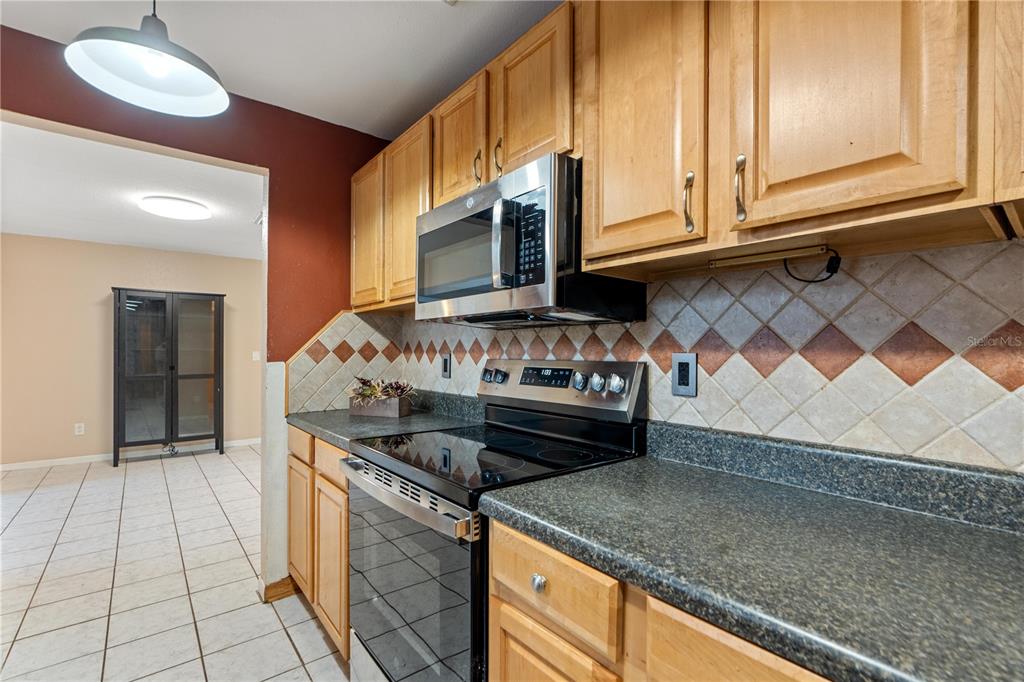 4008 Windswept Avenue Spring Hill, FL 34606 - Photo 11 of 32 a kitchen with stainless steel appliances granite countertop a stove and a sink
