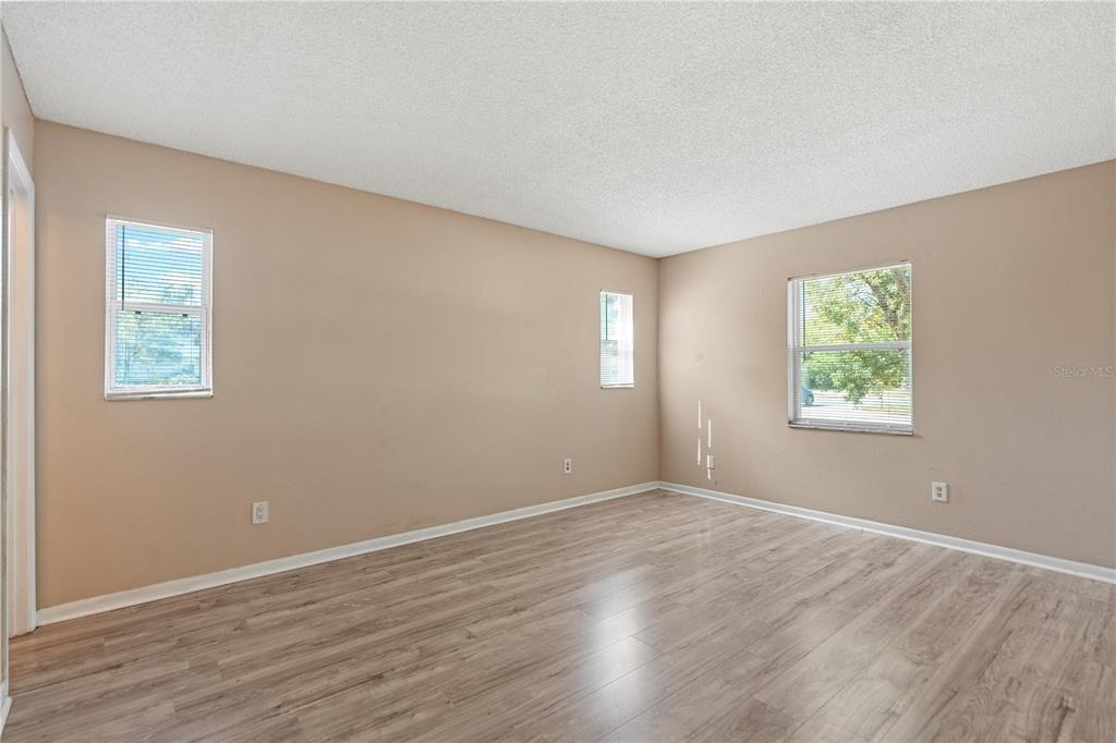 4008 Windswept Avenue Spring Hill, FL 34606 - Photo 16 of 32 a view of an empty room with wooden floor and a window