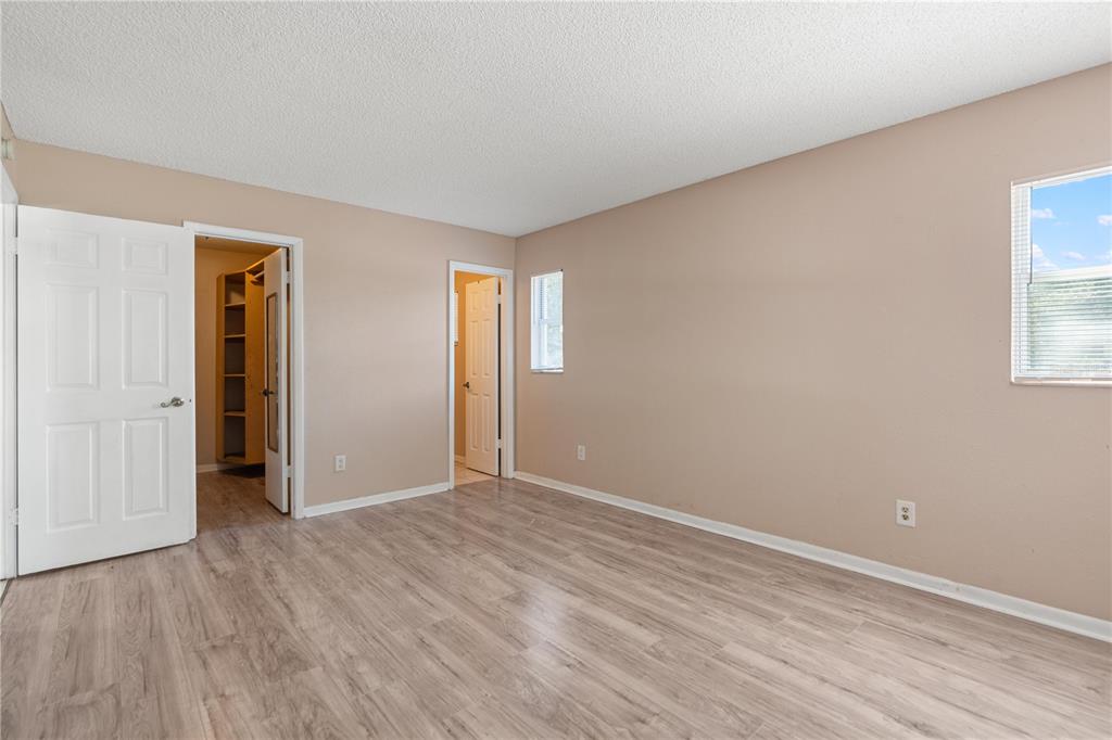 4008 Windswept Avenue Spring Hill, FL 34606 - Photo 17 of 32 a view of an empty room with wooden floor and a window