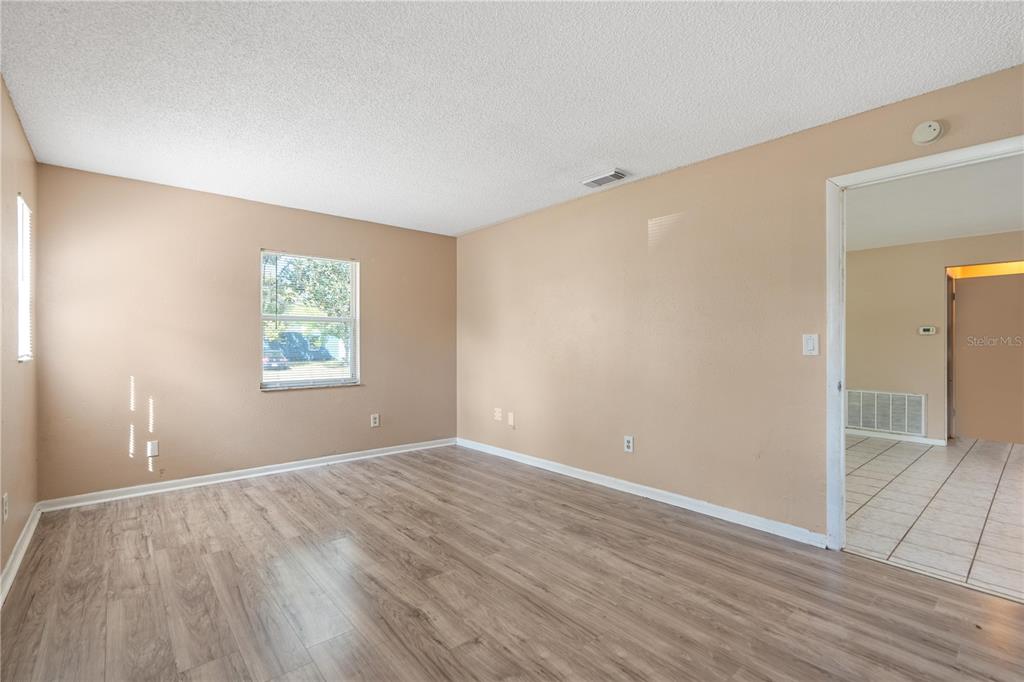 4008 Windswept Avenue Spring Hill, FL 34606 - Photo 18 of 32 an empty room with wooden floor and windows