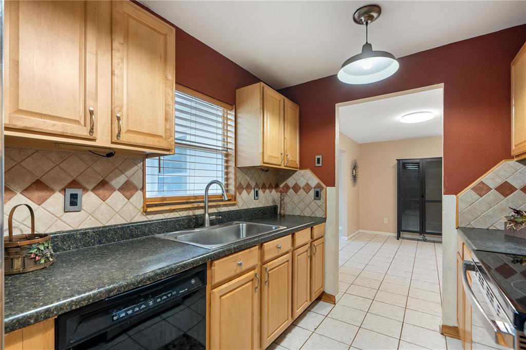 4008 Windswept Avenue Spring Hill, FL 34606 - Photo 10 of 32 a kitchen with stainless steel appliances granite countertop a sink and cabinets