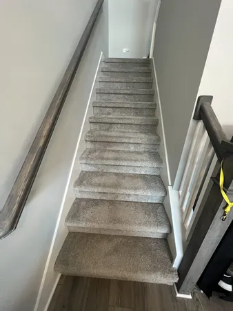a view of staircase and rug