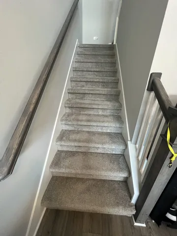 a view of staircase and rug