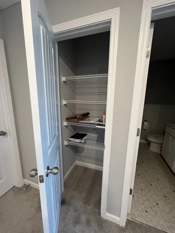 a view of kitchen with granite countertop cabinets and refrigerator