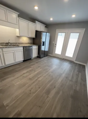 a kitchen with stainless steel appliances granite countertop a stove a sink and a microwave