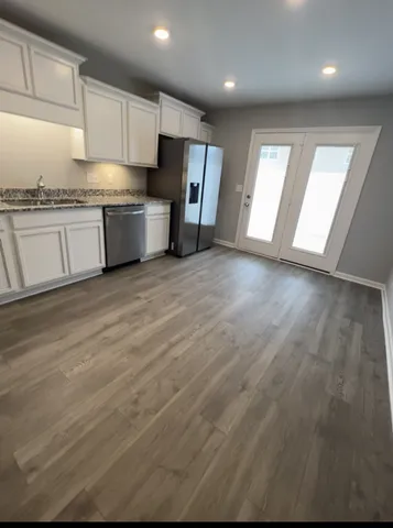 a kitchen with stainless steel appliances granite countertop a stove a sink and a microwave