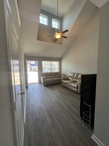 a view of a livingroom with furniture and a ceiling fan