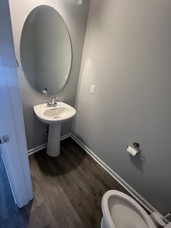 a bathroom with a sink mirror and toilet