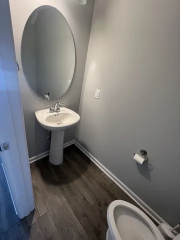 a bathroom with a sink mirror and toilet