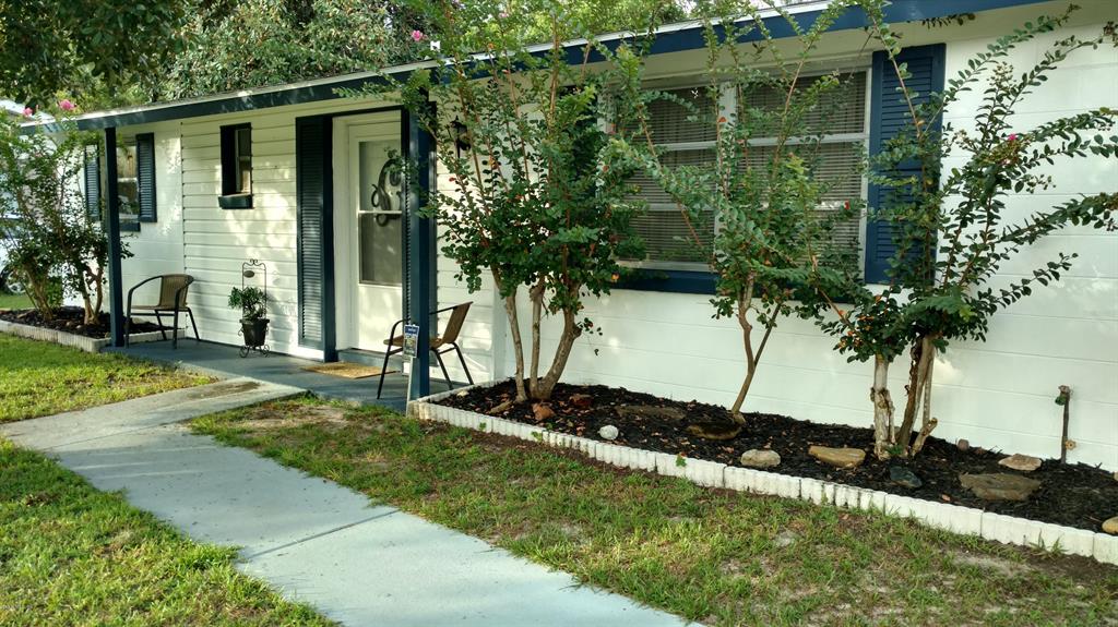14457 Southwest 38th Terrace Road Ocala, FL 34473 - Photo 1 of 1 a front view of a house with a yard