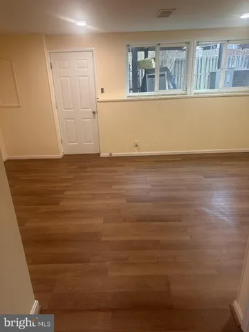 a view of a room with wooden floor