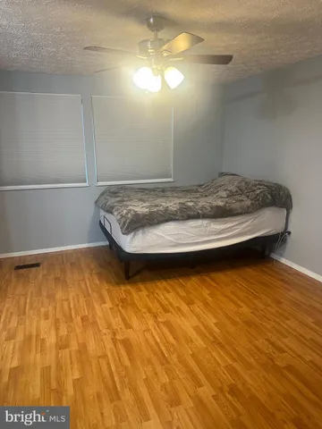 a view of kitchen with refrigerator and microwave