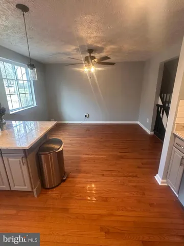 a view of a house with wooden fence