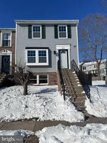 a view of a house with wooden fence
