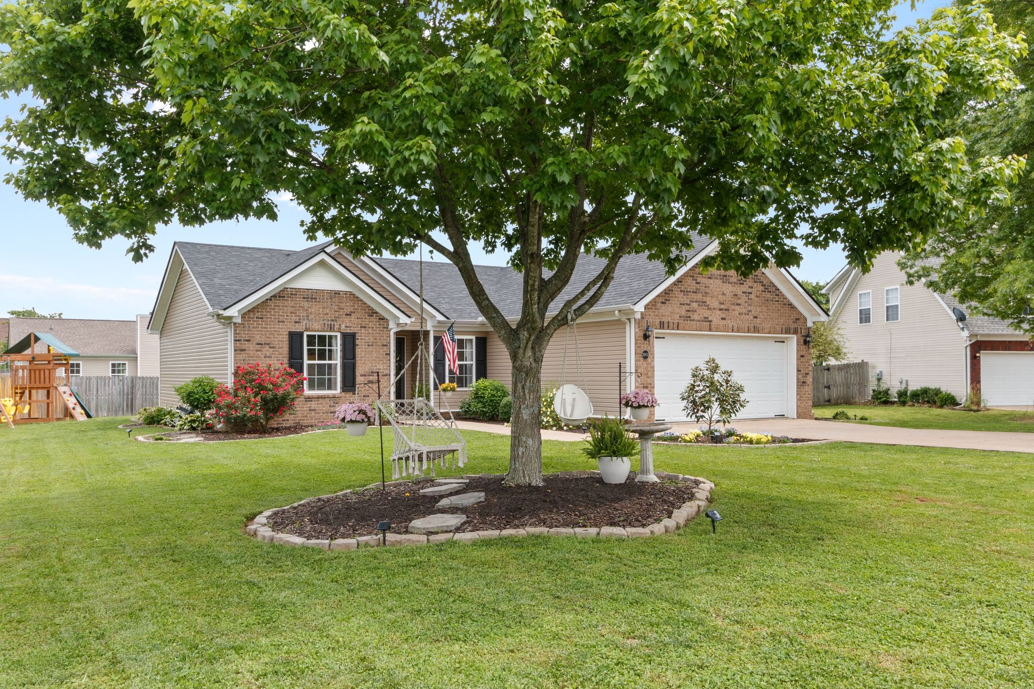 3003 Pandell Court Spring Hill, TN 37174 - Photo 2 of 22 a front view of a house with a yard and trees