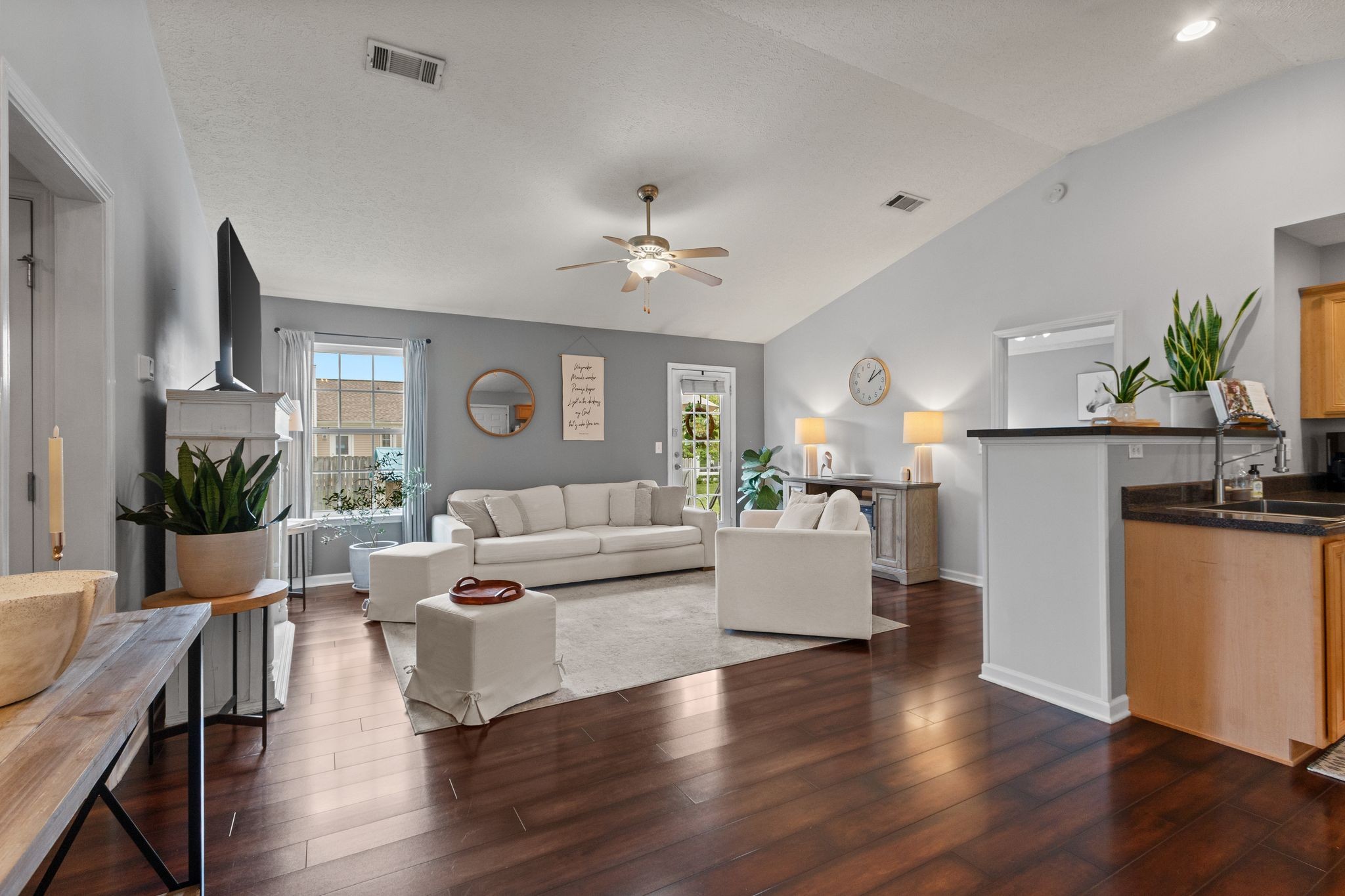 3003 Pandell Court Spring Hill, TN 37174 - Photo 4 of 22 a living room with couches and kitchen view with wooden floor