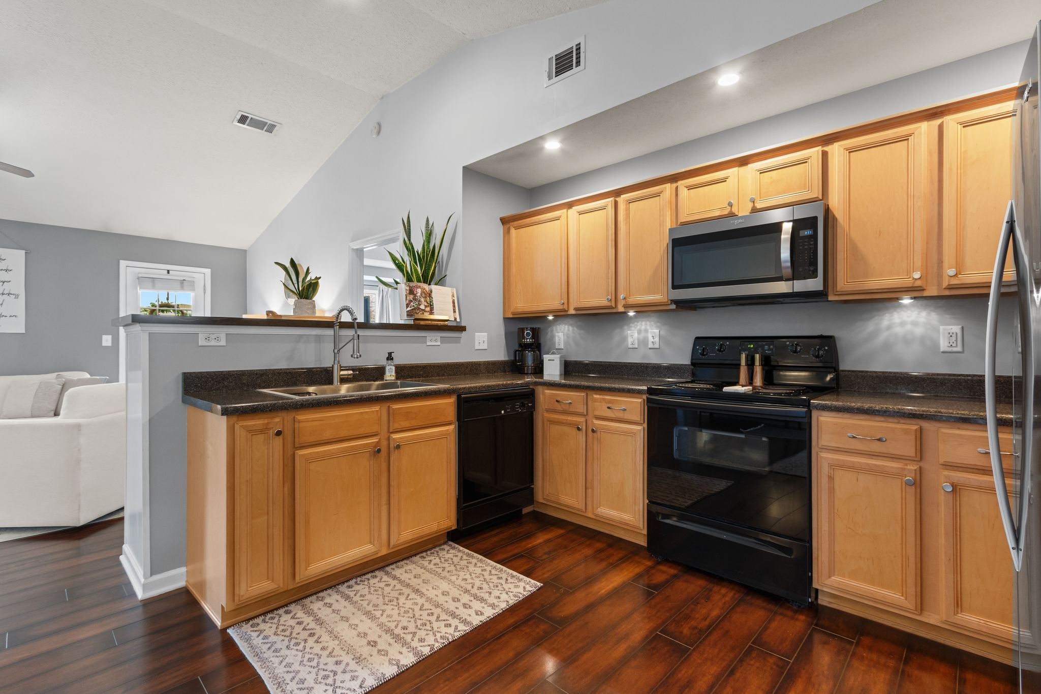 3003 Pandell Court Spring Hill, TN 37174 - Photo 7 of 22 a kitchen with stainless steel appliances granite countertop a stove a sink and a microwave