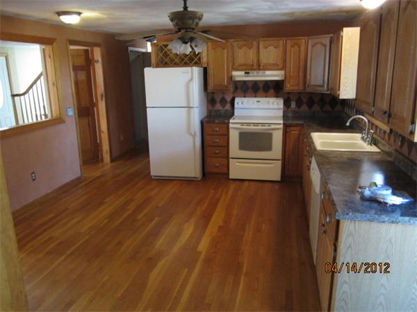 24 Hollis Road Lunenburg, MA 01462 - Photo 3 of 27 a kitchen with a refrigerator wooden floor and a sink