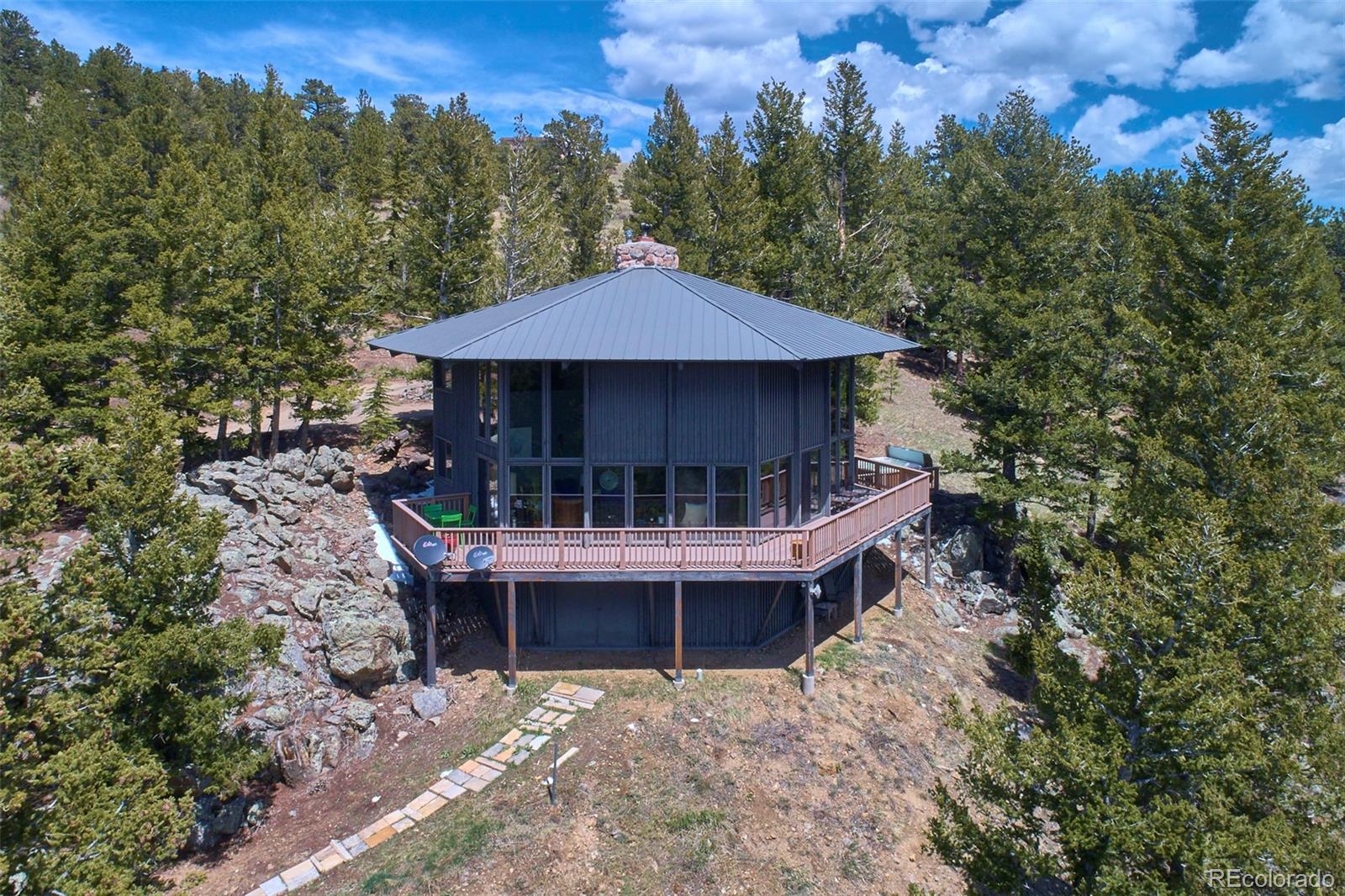 918 Ridge Road Nederland, CO 80466 - Photo 1 of 35 a view of house with roof deck and seating space