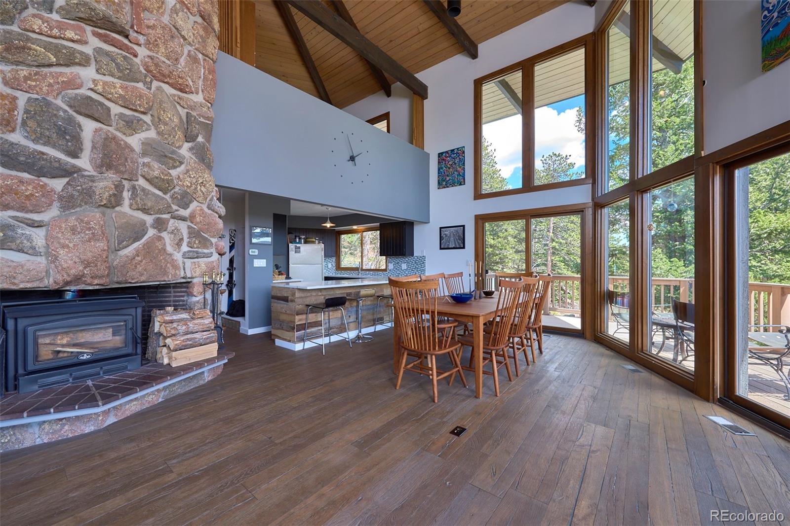 918 Ridge Road Nederland, CO 80466 - Photo 13 of 35 a dining room with furniture a fireplace and wooden floor