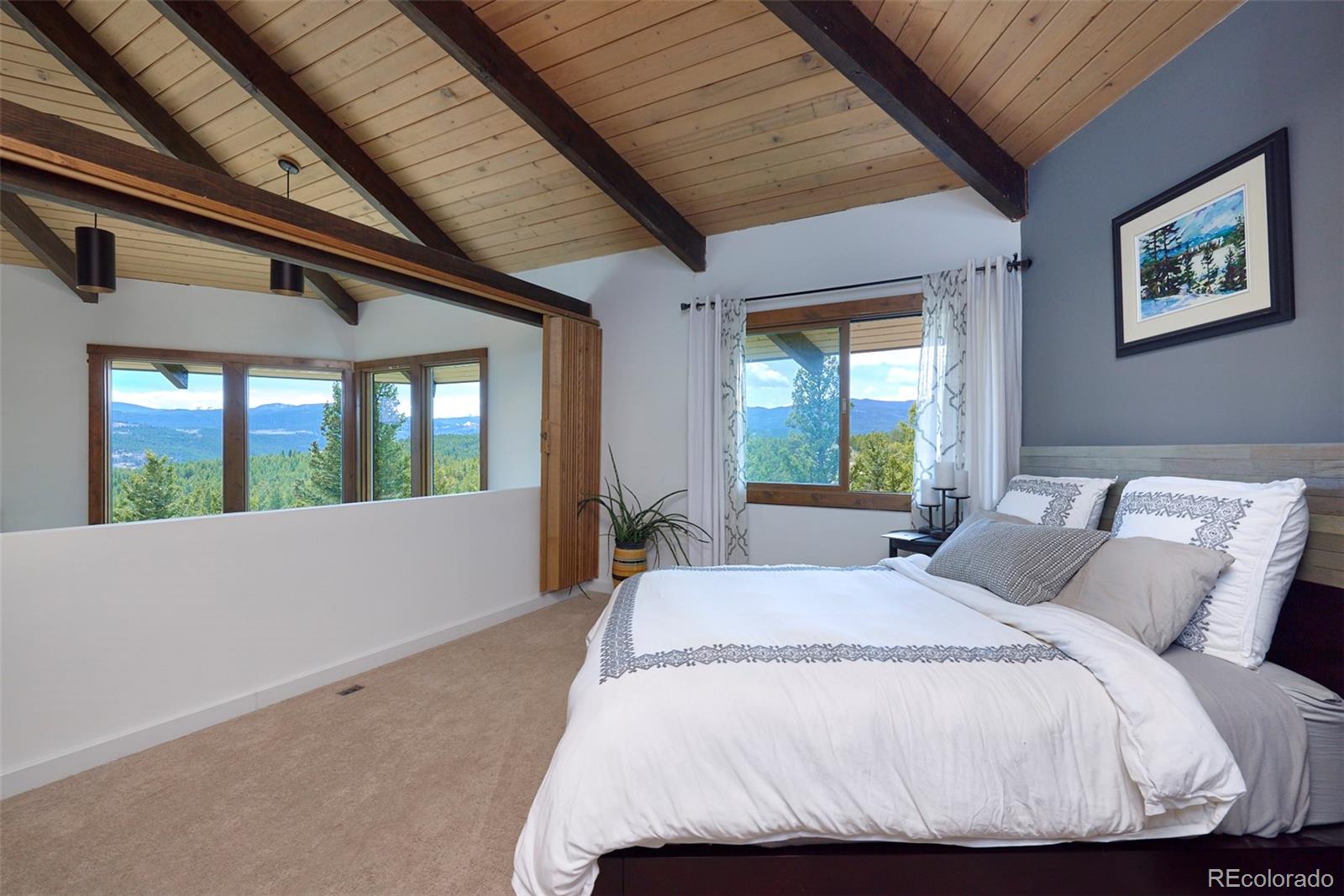918 Ridge Road Nederland, CO 80466 - Photo 15 of 35 a bed sitting in a bedroom next to a window