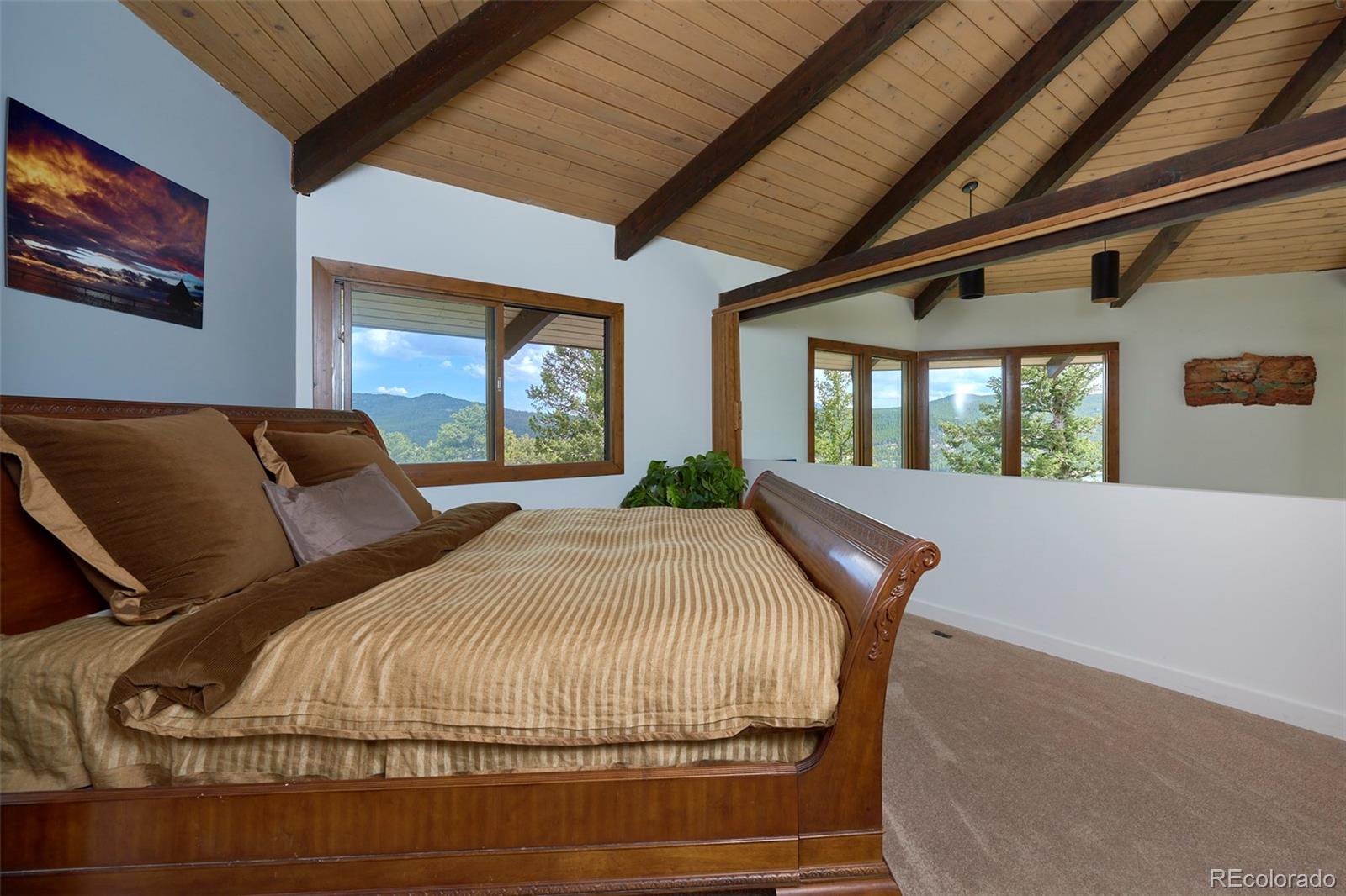 918 Ridge Road Nederland, CO 80466 - Photo 17 of 35 a bed sitting in a bedroom next to a window
