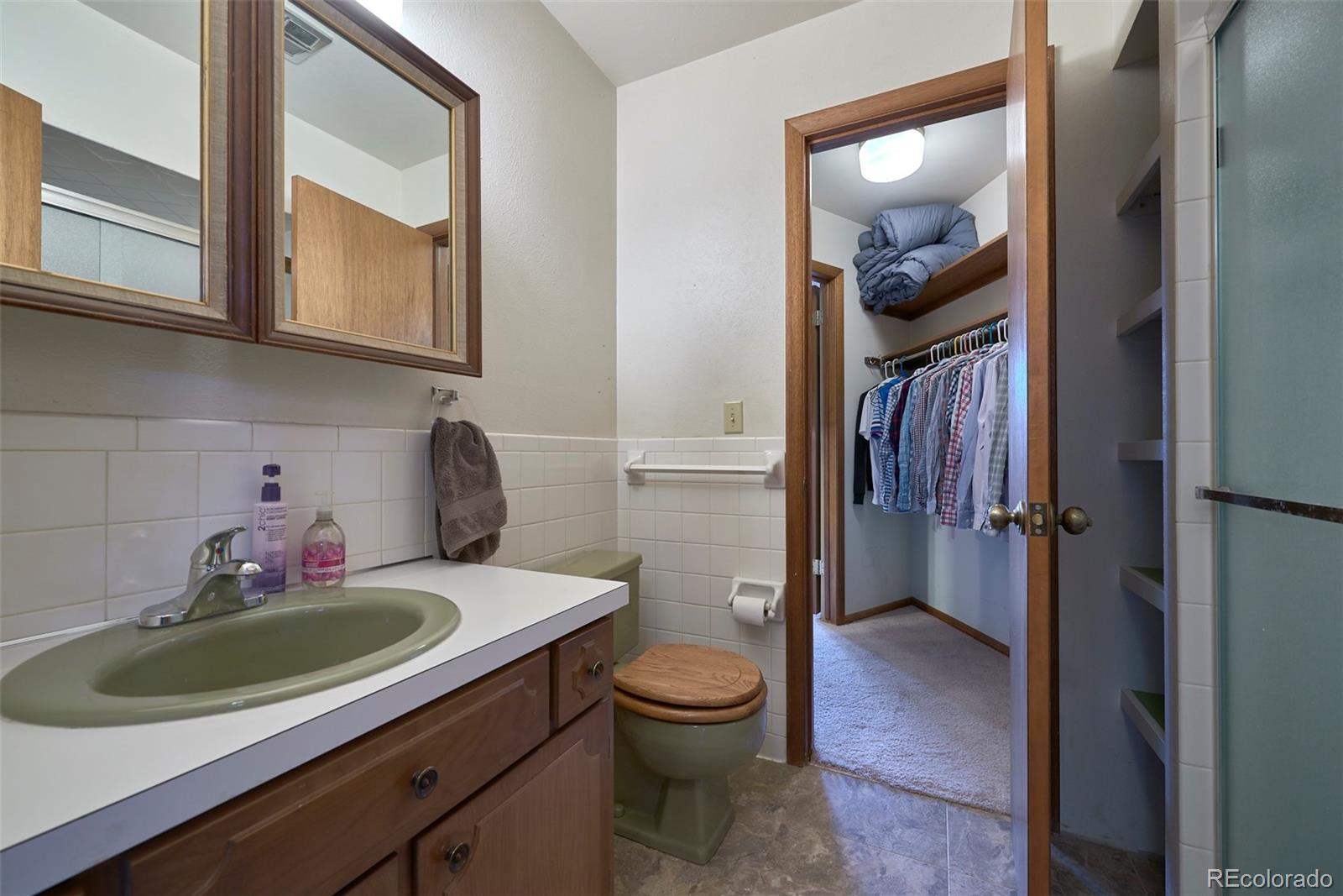 918 Ridge Road Nederland, CO 80466 - Photo 18 of 35 a bathroom with a toilet a sink and mirror