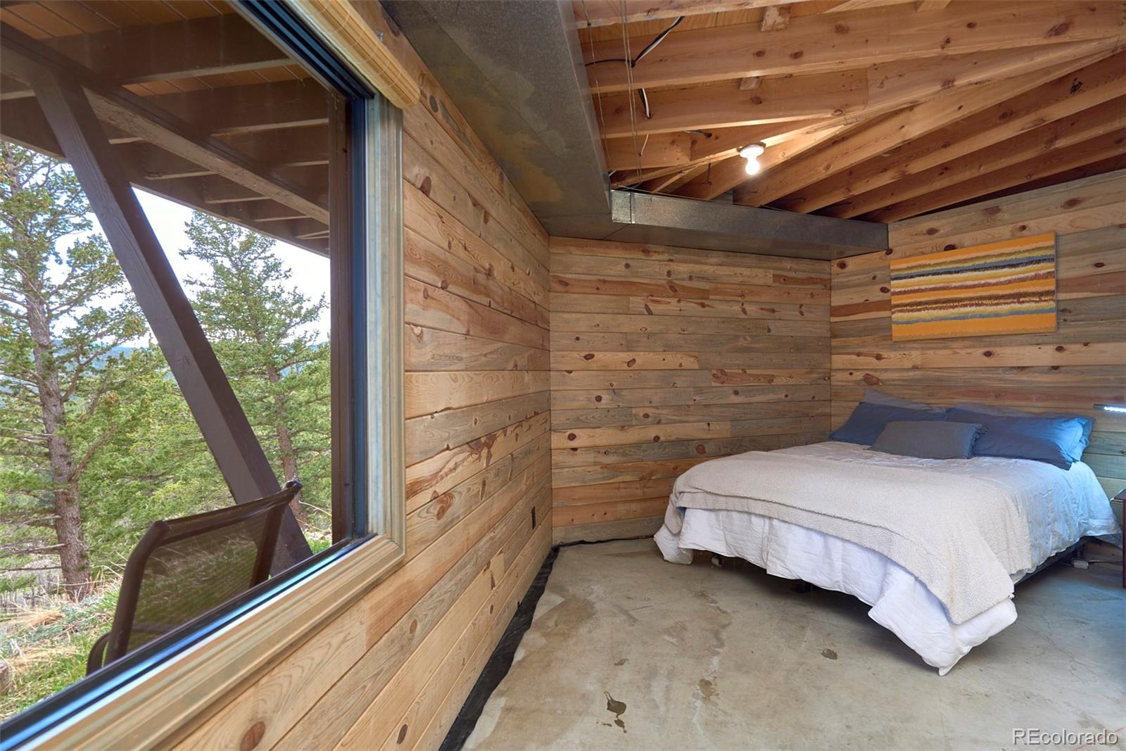 918 Ridge Road Nederland, CO 80466 - Photo 20 of 35 a bedroom with a bed and a large window