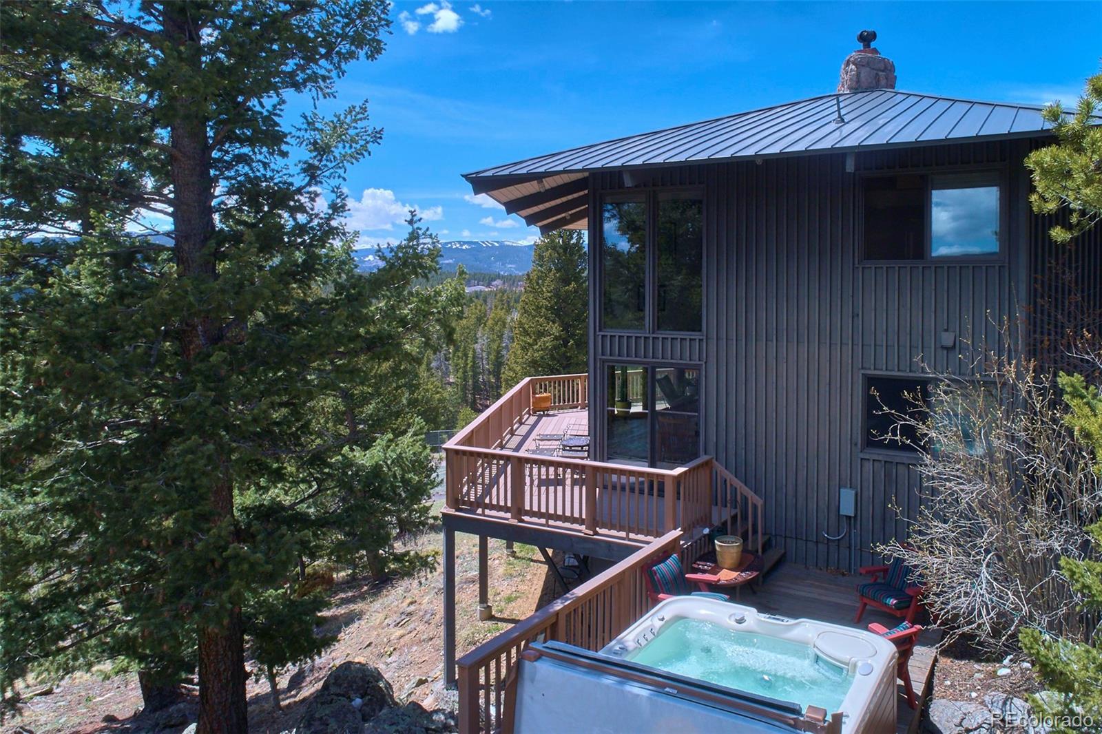 918 Ridge Road Nederland, CO 80466 - Photo 4 of 35 a small wooden house with a large tree and wooden fence