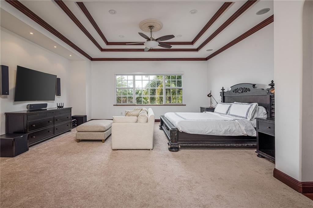 6465 Southwest 178th Avenue Southwest Ranches, FL 33331 - Photo 15 of 36 a spacious bedroom with a bed and a flat screen tv