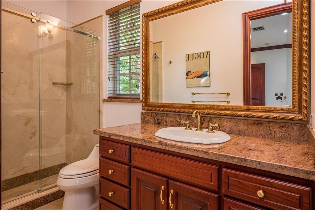 6465 Southwest 178th Avenue Southwest Ranches, FL 33331 - Photo 22 of 36 a bathroom with a granite countertop sink toilet and shower