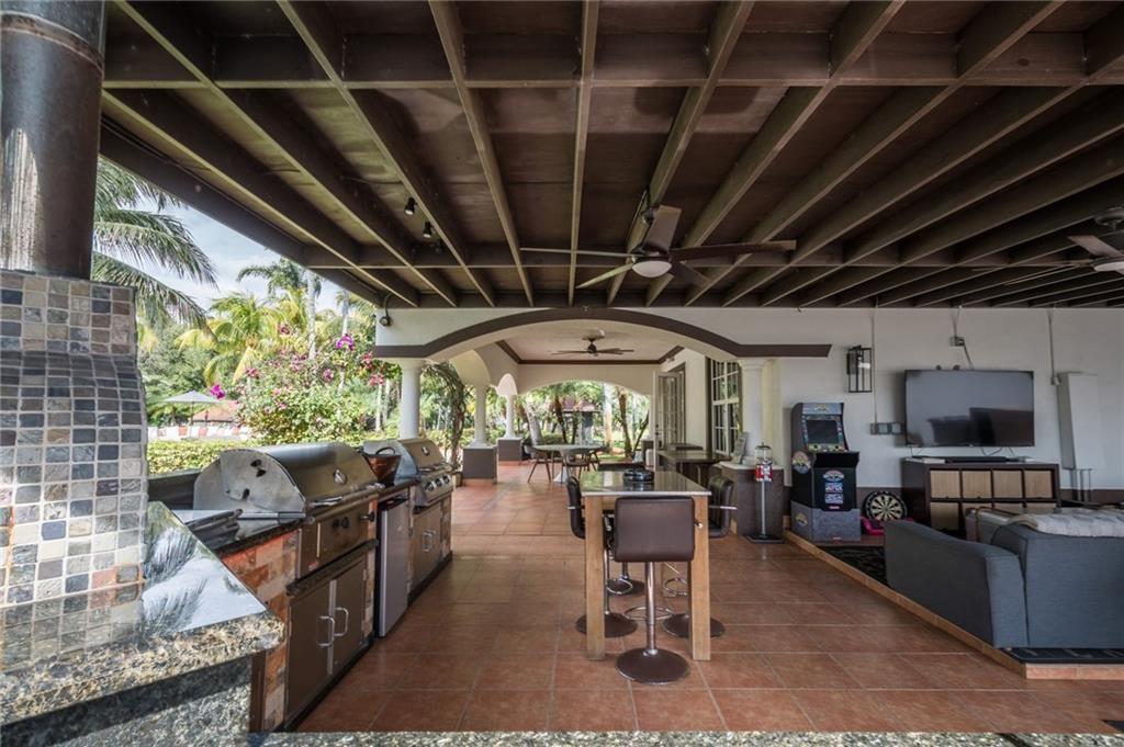 6465 Southwest 178th Avenue Southwest Ranches, FL 33331 - Photo 25 of 36 a living room with lots of furniture and a flat screen tv