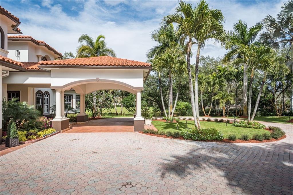 6465 Southwest 178th Avenue Southwest Ranches, FL 33331 - Photo 4 of 36 a front view of multi story residential apartment building with yard and green space