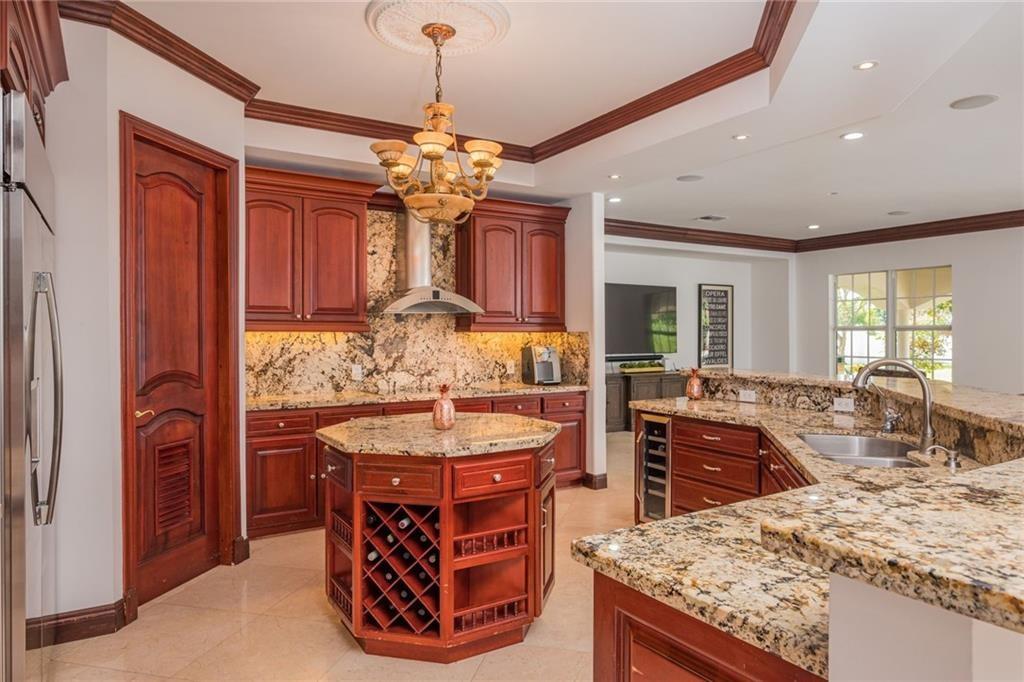6465 Southwest 178th Avenue Southwest Ranches, FL 33331 - Photo 8 of 36 a kitchen with stainless steel appliances granite countertop a stove oven and a refrigerator