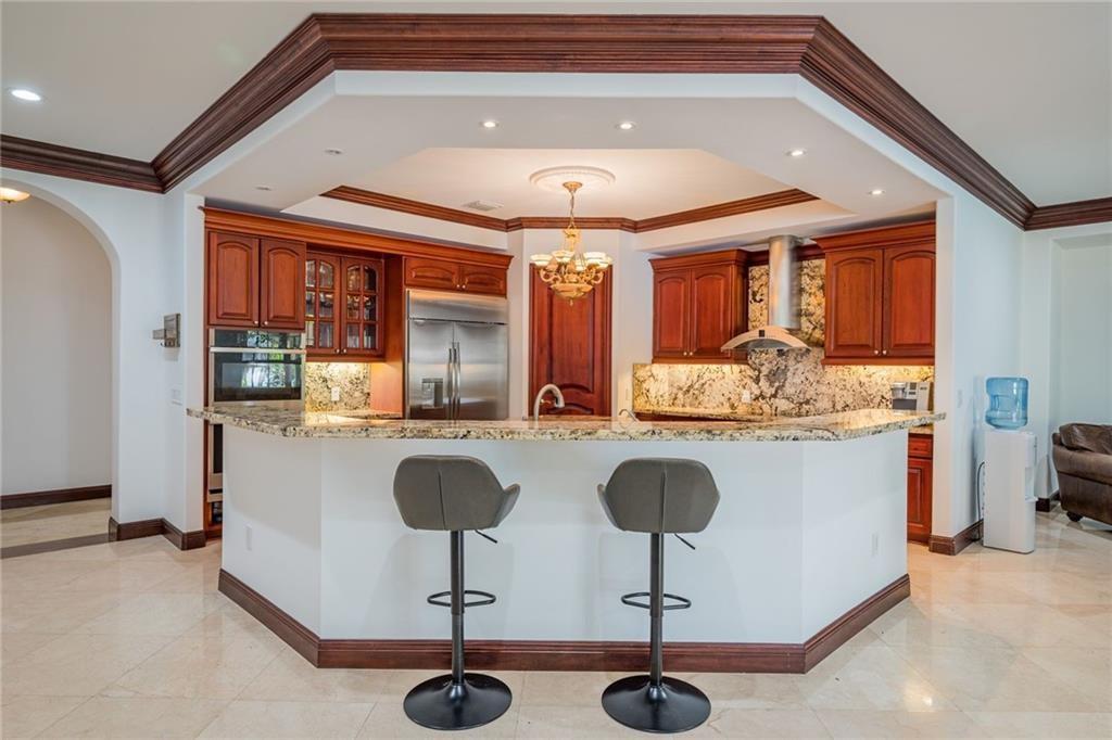 6465 Southwest 178th Avenue Southwest Ranches, FL 33331 - Photo 9 of 36 a kitchen with stainless steel appliances granite countertop a sink and cabinets