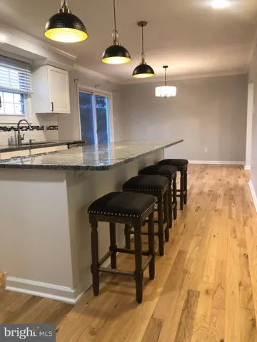 a kitchen with a table and chairs in it