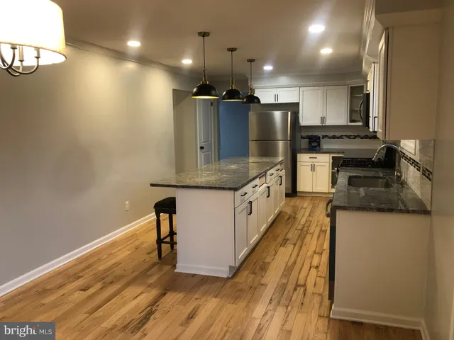 a kitchen with stainless steel appliances granite countertop a sink refrigerator and microwave