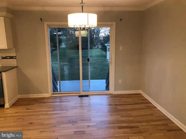 a view of a room with wooden floor gym equipment and windows