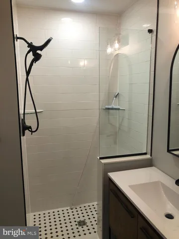 a bathroom with a toilet and a black white checkered floor