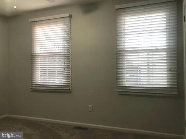 a bathroom with a toilet and a shower curtain
