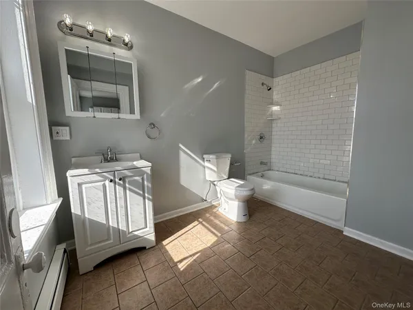 a bathroom with a toilet a sink and bathtub